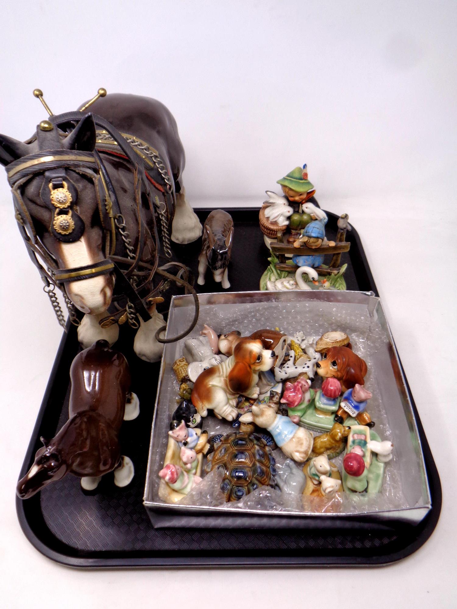 A tray containing assorted ceramic ornaments to include shire horses,