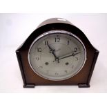 A 1930's oak cased Everite mantel clock with silvered dial