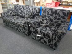 A three piece contemporary lounge suite in black leaf fabric comprising two seater settee,