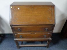 A 1920's carved fall front bureau on stand