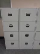 Two four drawer metal filing cabinets with keys