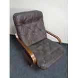 A 20th century swivel armchair upholstered in brown buttoned leather