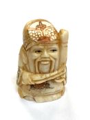 A Japanese carved bone netsuke - Village elder with long beard.