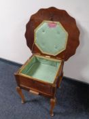 A shaped oak sewing box on cabriole legs