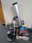A Zennox telescope on stand together with a National Geographic Dobson telescope and a box of