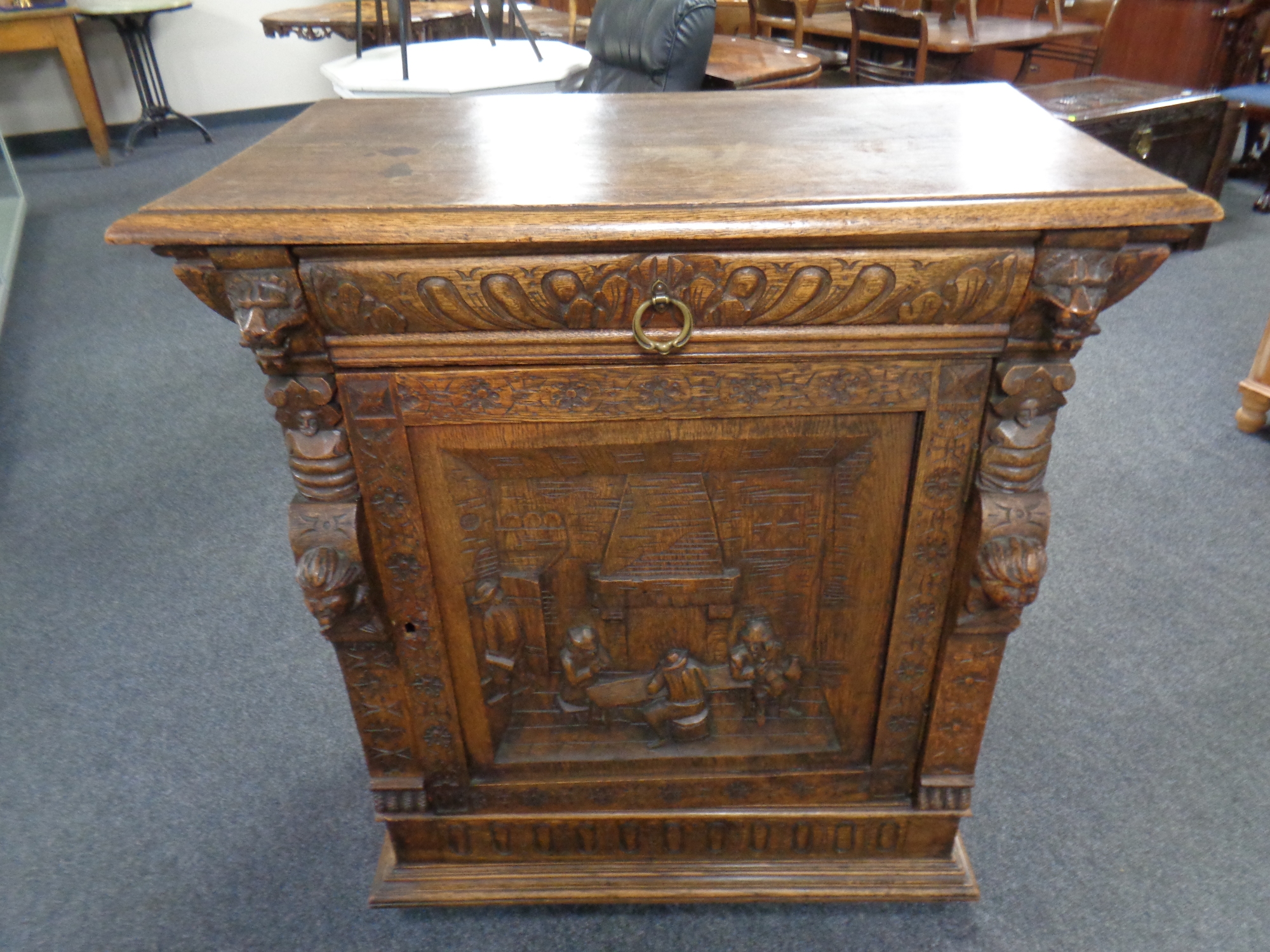 A 19th Century continental heavily carved oak cabinet, fitted with a drawer above, width 90cm.