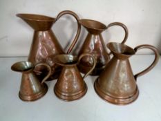 A vintage set of five graduated Victorian copper measuring jugs.