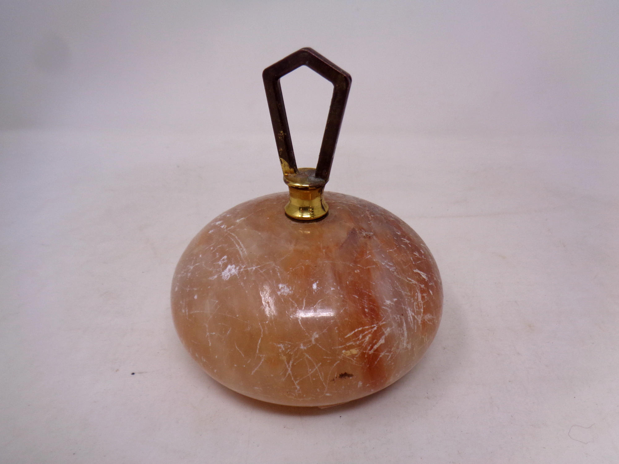 An alabaster curling stone style paperweight