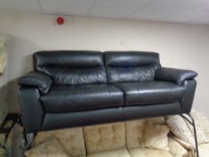 A contemporary black leather settee