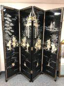 A Japanese four fold lacquered screen with mother of pearl inlay,