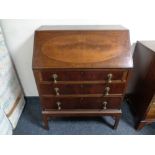 An Edwardian inlaid mahogany writing bureau fitted three drawers beneath