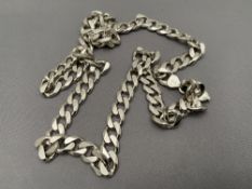 A silver curb chain,