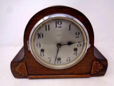 A 1930's oak-cased Smiths Enfield mantel clock, with silvered dial.