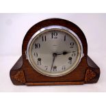 A 1930's oak-cased Smiths Enfield mantel clock, with silvered dial.