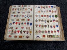 An early 20th century scrapbook containing cigarette cards and cuttings