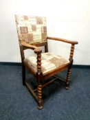 An oak Edwardian armchair with barley twist supports