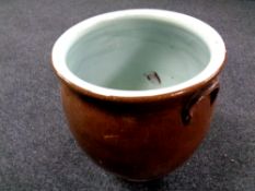 An antique glazed pottery crock pot,