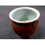 An antique glazed pottery crock pot,