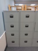 Two four drawer metal filing cabinets with keys