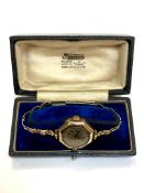 An antique lady's wristwatch with 9ct gold front and back on rolled gold bracelet