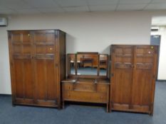 A four piece 1920's carved oak bedroom suite : ladies and gents wardrobes,