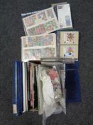 A box of albums and folders of stamps, postcards,