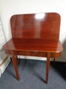 A 19th century inlaid mahogany turnover top D-shaped table