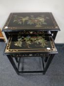 A nest of two black lacquered Japanese style tables