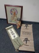 A needlework panel depicting a geisha, framed, together with a 20th century geisha doll,