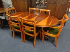 A yew wood oval extending dining table,