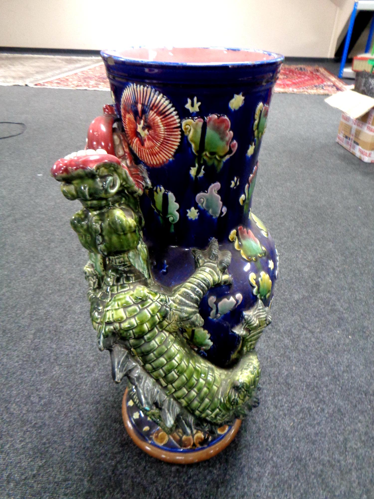 A Majolica style stick pot surmounted by a dragon