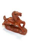 A Japanese carved fruitwood netsuke - Prancing pony.