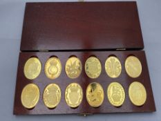 A boxed set of twelve silver gilt Arms of the Prince and Princess of Wales coins