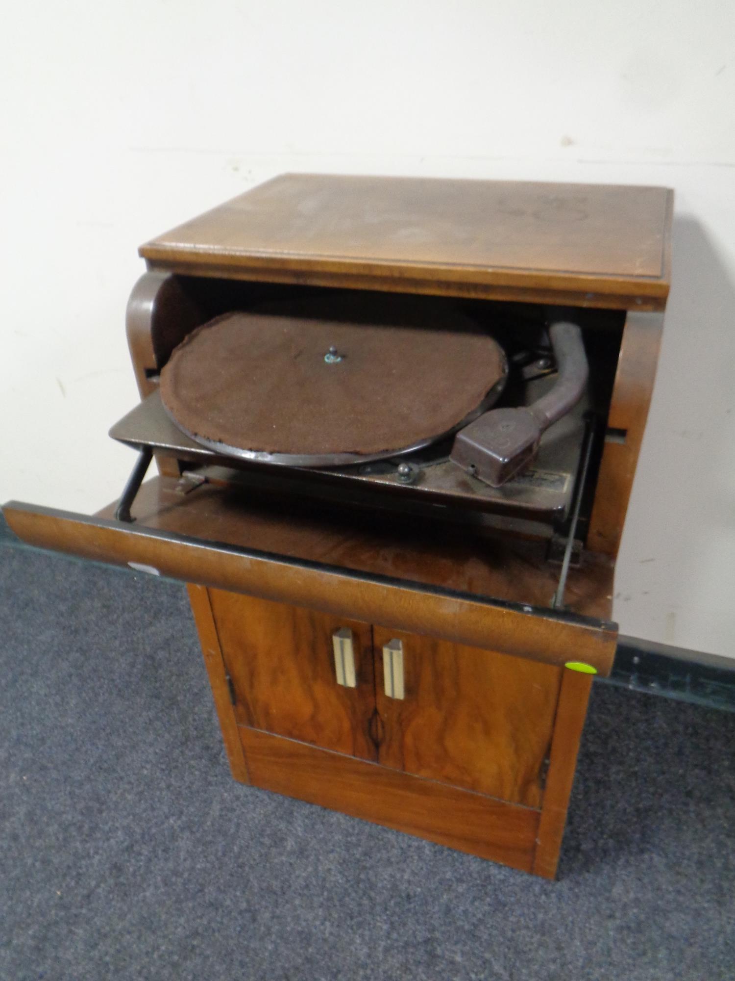 An early 20th century burr walnut record cabinet