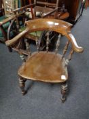 An antique elm and beech smoker's armchair