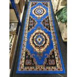 A machine made Persian designed runner on blue ground