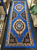 A machine made Persian designed runner on blue ground