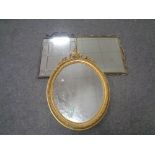 A wrought iron framed mirror together with a brass framed mirror and a further oval gilt mirror