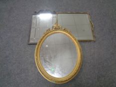 A wrought iron framed mirror together with a brass framed mirror and a further oval gilt mirror