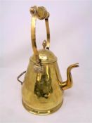 A brass kettle with swing handle