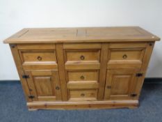 A pine sideboard fitted with cupboards and drawers