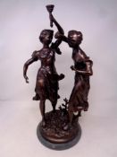 A 20th century patinated bronze sculpture depicting two figures dancing