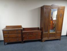 A three piece carved oak bedroom suite : mirror door wardrobe,