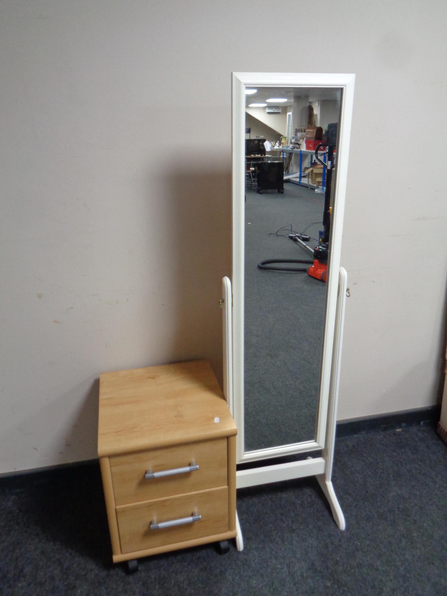 A pine effect two drawer bedside chest on castors together with a cheval mirror