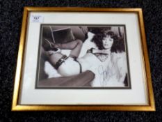 Joan Collins : A signed monochrome semi-erotic photograph, 17 cm x 23 cm, framed.