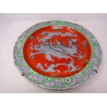 A 19th Century Masons scalloped-edge wall plaque depicting a dragon, diameter 37cm.