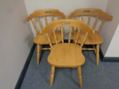 A set of three pine elbow chairs