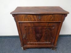 A continental mahogany side cabinet fitted a drawer