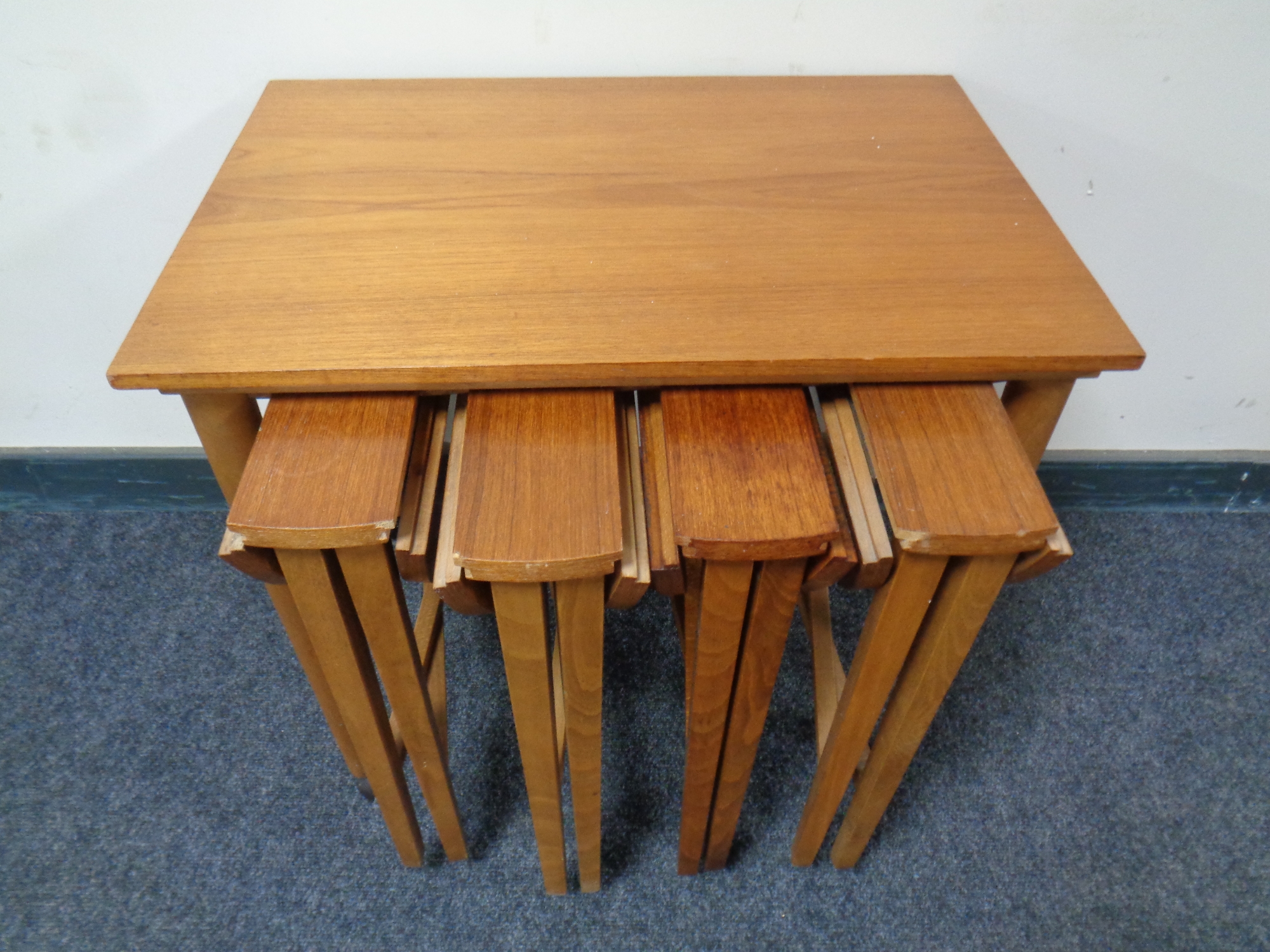 A 20th century beech nest of five stowaway tables