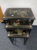 A nest of three black lacquered Japanese style tables